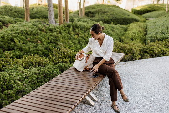 Korean woman enjoying a peaceful moment in a serene park setting