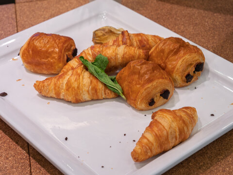 Delicious Assorted Pastries: Croissants and Chocolate Rolls