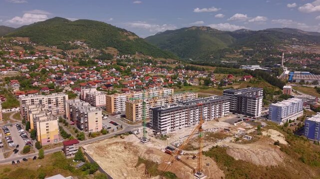 Aerial View of Construction Site with Two Cranes Flying Towards New Residential District Nova Vogosca Bosnia and Herzegovina