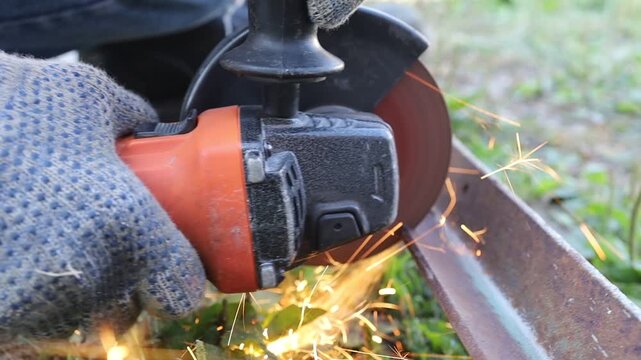 Cutting metal with a grinder in outdoor setting