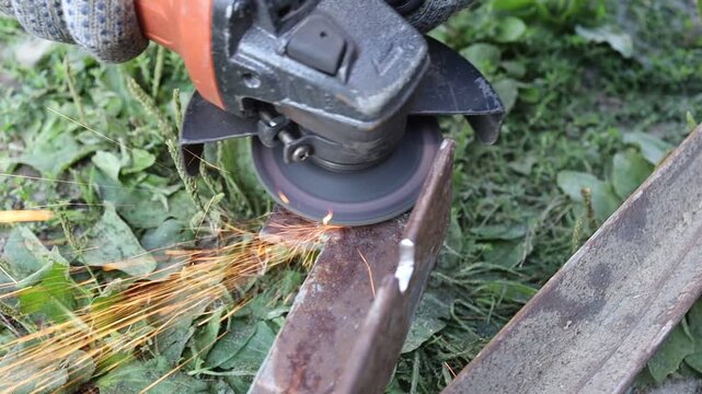 Grinding metal with a tool in an outdoor setting