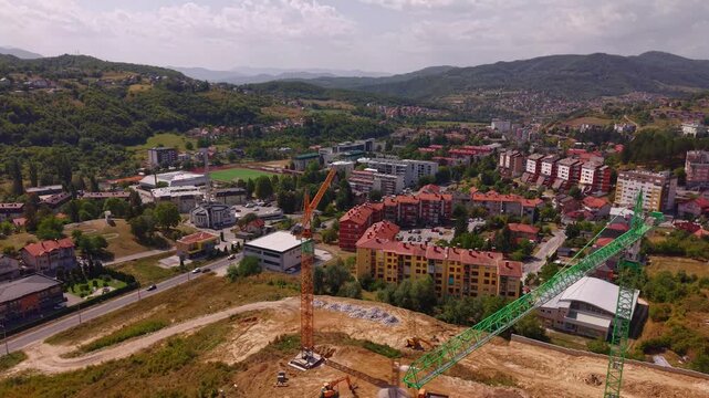 Aerial Drone Shot of Two Construction Cranes Flying Towards Town Center in Vogosca Bosnia and Herzegovina