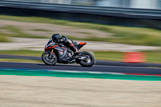 Aprilia RSV4 Racing Bike Pushing Hard Through Track BendDutch Angle View of Yamaha Superbike Accelerating Out of Corner in Slovakia Ring in Slovakia on August 29th.