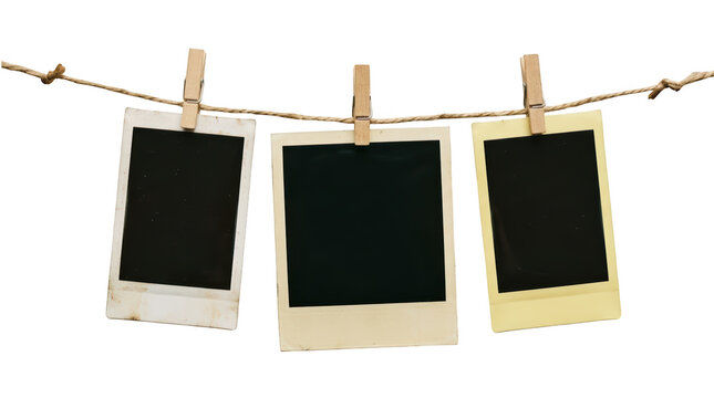 Three blank instant photos hanging on a string isolated on transparent background