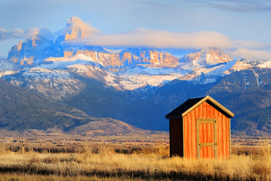 Tetons Mountains with Red Shed or Building in Foreground in American West Rugged Mountains Granite Peaks Showcasing Beautiful Wilderness in the United States