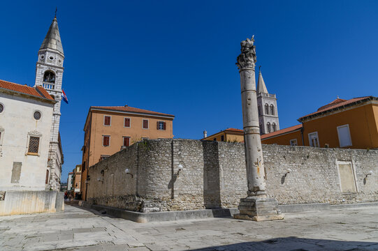 Roman Forum square with ancient column and church bell towers, Zadar, Croatia