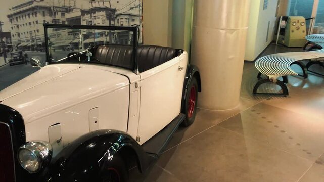 Showcase of rare vintage classic cars displayed in a museum hall featuring retro convertible sports vehicles, antique automobiles, and beautifully restored historical motor cars on luxury exhibition 