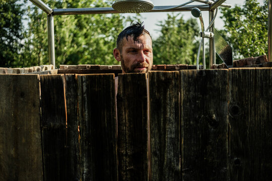 man taking a shower in the garden