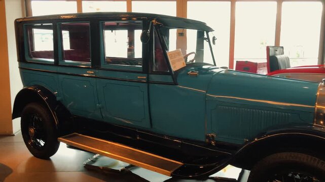 Showcase of rare vintage classic cars displayed in a museum hall featuring retro convertible sports vehicles, antique automobiles, and beautifully restored historical motor cars on luxury exhibition 
