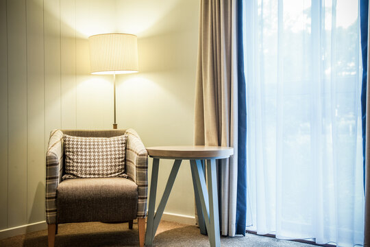chair and lamp by the window - cozy reading corner