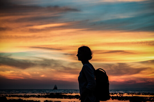 woman silhouette watching amazing sunset on the beach in Krabi  Thailand