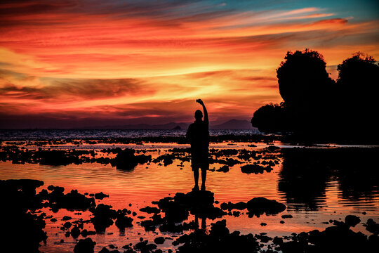 man silhouette watching amazing sunset on the beach in Krabi  Thailand
