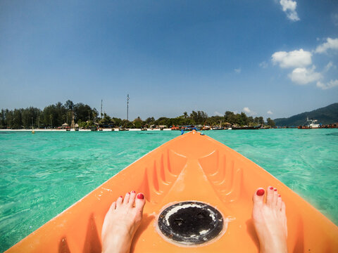  kayaking in crystal clear tropical waters - kayak heading to isolated beach in Ko Tarutao national park