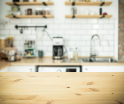 empty wooden tabletop and blurred kitchen mock up for product display