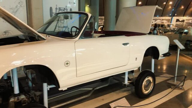 Showcase of rare vintage classic cars displayed in a museum hall featuring retro convertible sports vehicles, antique automobiles, and beautifully restored historical motor cars on luxury exhibition 
