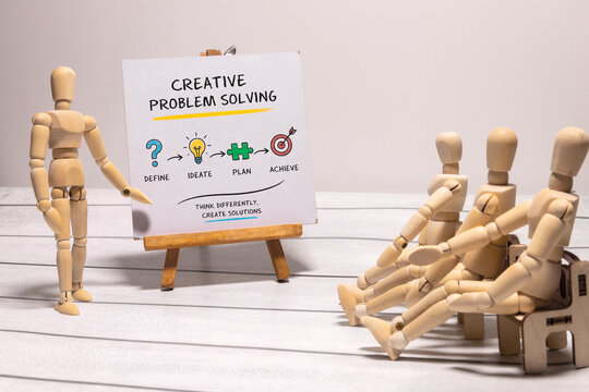 Creative Problem Solving Process with Wooden Mannequins in Team Workshop.
