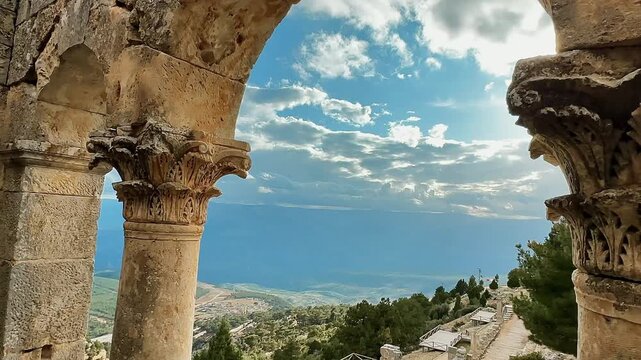 Alahan Monastery in Mut, Mersin, T&uuml;rkiye. Camera moves between ancient stone columns, revealing a panoramic mountain and valley view.