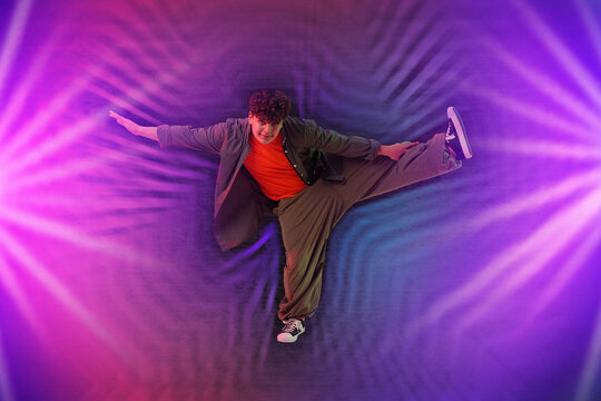 Young hip-hop dancer posing in neon lights. Bright creative poster