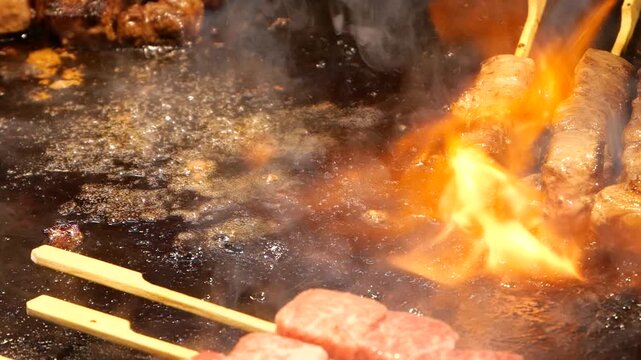 Japanese Aburi Teppanyaki Kushiyaki of flame searing on meat skewers