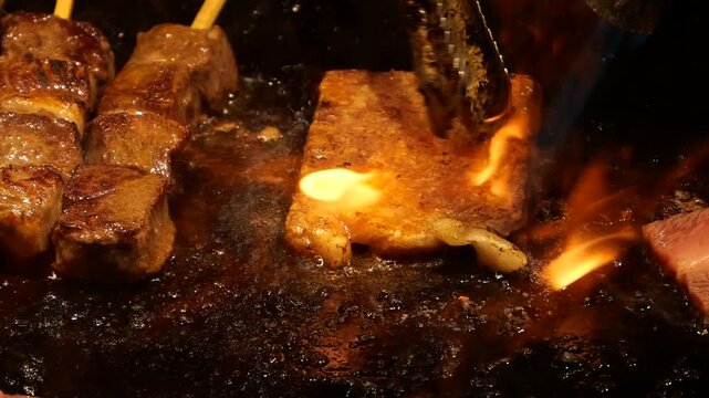 Japanese Aburi Teppanyaki Kushiyaki of flame searing on meat skewers