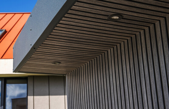 Slatted exterior cladding with recessed soffit lights
