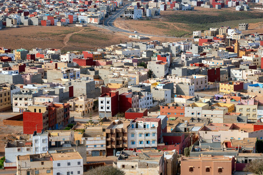 View of the colorful buildings and urban layout of the town of Mirleft, set against the arid landscape of the region in Mirleft, Guelmim-Oued Noun, Morocco.