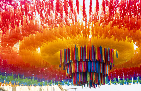 View of colorful papel picado decorations hanging above a street in Oaxaca, Oaxaca, Mexico.