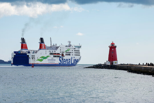 Stena line "Adventurer" ferry sails past red Poolbeg lighthouse as it departs Dublin Port, Irish Sea, travelling to Holyhead, UK. Car, freight and passenger transport vessel. Ireland
