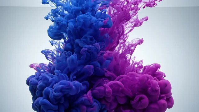 Abstract swirl of blue and purple ink clouds mixing in water against a clean white background