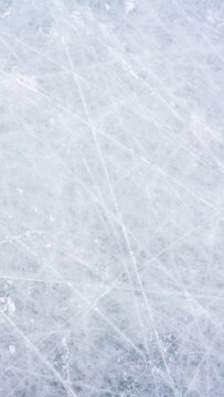 Ice background with marks from skating and hockey, blue texture of rink surface with scratches