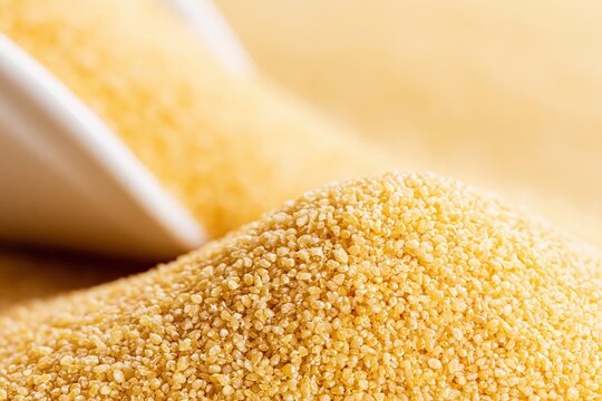 Bulgur wheat grains pile macro shot in warm yellow organic light