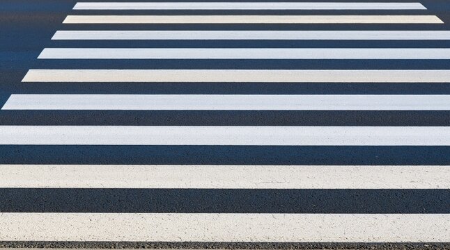 Zebra crossing on asphalt road close up