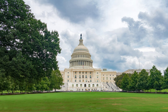 United States Capitol anchors a tree lined avenue in Washington DC.