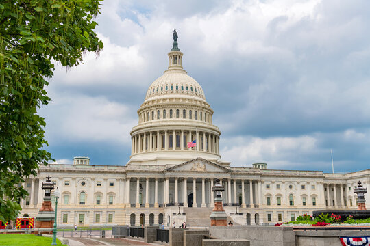 Neoclassical Capitol building appears across landscaped public grounds on Capitol Hill.