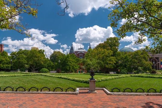 Green garden lawn frames the historic Smithsonian Castle in Washington, DC.