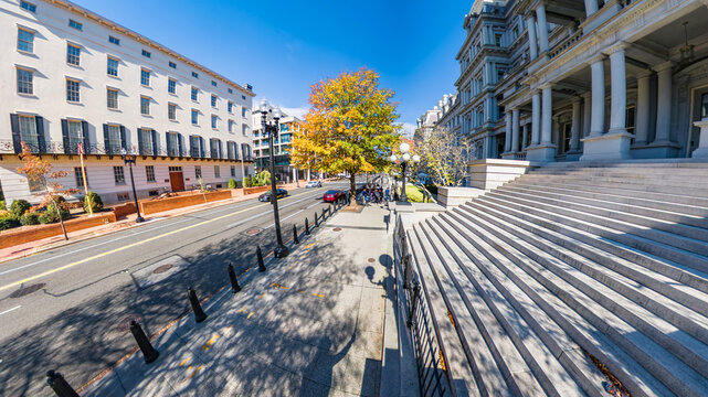 Wide angle view shows the Eisenhower Executive Office Building and Washington streetscape.