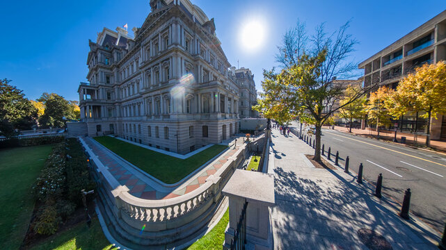 Wide angle view shows the Eisenhower Executive Office Building and Washington streetscape.