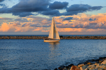 Sailboat entering the port of Gdansk at sunset, Poland. © Patryk Kosmider