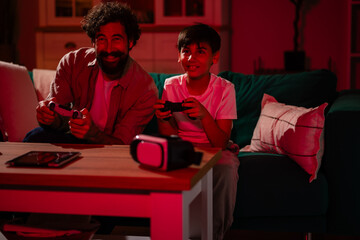 Father and son bonding playing video games © Zoran Jesic