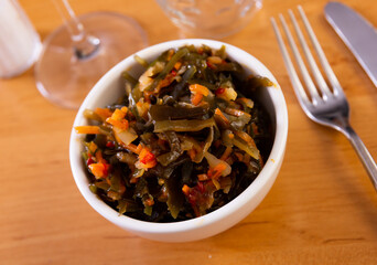 There is portion of seaweed salad with carrot, onion and peppers © JackF
