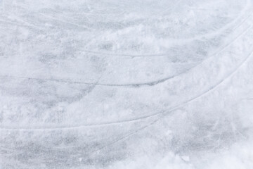 Naklejka premium Ice background with marks from skating and hockey, blue texture of rink surface with many scratches