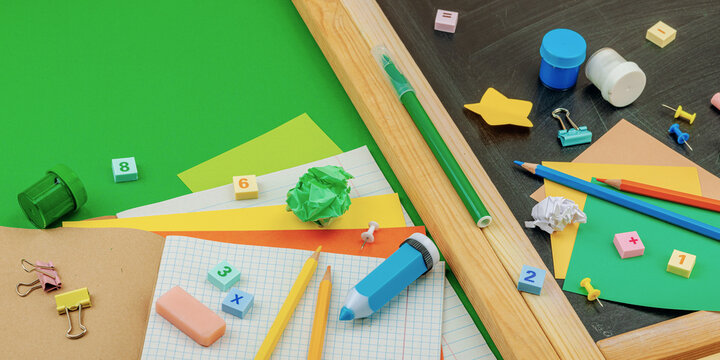 Eco-friendly flat lay with school supplies, wooden toys on green background. Zero waste lifestyle