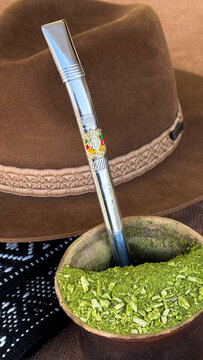 A *chimarr&atilde;o* (mate) and a hat on the table&mdash;symbols of *ga&uacute;cho* culture and tradition (southern Rio Grande do Sul, Brazil). Farroupilha Week, Ga&uacute;cho Day.