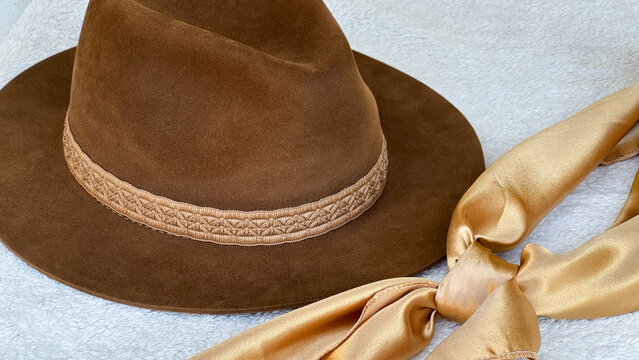 A hat and a *ga&uacute;cho* neckerchief on the table&mdash;symbols of *ga&uacute;cho* culture and tradition (southern Rio Grande do Sul, Brazil). Farroupilha Week honors the past, a history that spans generations.