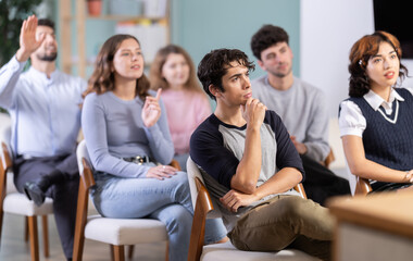 Fototapeta premium Lecture room is filled with listeners, students listen to teacher. Company managers during training, introductory training for staff, professional development courses, educational seminar.
