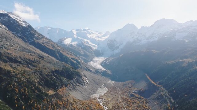 Aerial view of a mountain range and valley on a clear day. Scenic natural landscape with peaks and slopes.