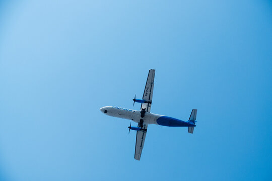 Yogyakarta, Indonesia - August 30, 2026: An ATR 72 turboprop aircraft operated by FlyJaya with registration PK-FJC flies against a clear blue sky.