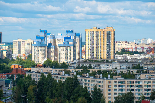 Modern city skyline panorama with residential apartment buildings under blue sky.
