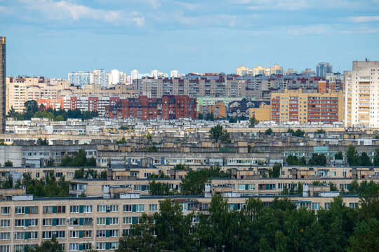 Modern city skyline panorama with residential apartment buildings under blue sky.
