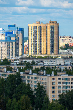 Modern city skyline panorama with residential apartment buildings under blue sky.
